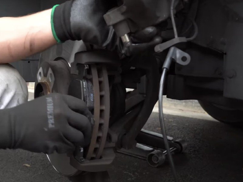 Picture of mechanic performing a disc brake job.