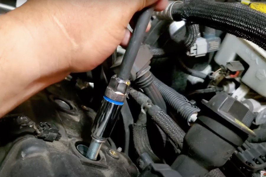 Mobile mechanic changing spark plugs in Long Beach.